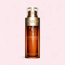 Clarins Double Serum bottle on a light pink background