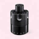 Black Azzaro perfume bottle on a light pink background