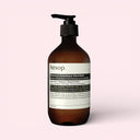 Aesop Eleos Aromatique Hand Balm 500ml bottle on a light pink background