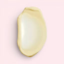 Yellow cream swatch of Aesop Eleos Aromatique Hand Balm 500ml on a light pink background