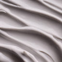 Close-up of gray cream texture of Aesop Eleos Aromatique Hand Balm with folds
