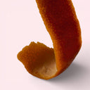 Close-up of an mandarin peel on a light pink background