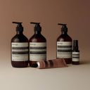 Aesop Resurrection Aromatique Hand Balm range products on a beige background