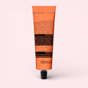 Orange tube of Aesop Rind Concentrate Body Balm 100ml on a light pink background