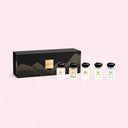 Set of Armani Prive perfume bottles with a black box on a pink background