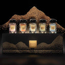 Set of five armani prive perfume bottles in a decorative box with decorative beads on a black background