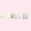 Armani Privé Les Eaux Hand Soaps Discovery Trio Set Packaging: Three square boxes of green (Thé Yulong/50g), pink (Pivoine Suzhou/50g) and blue (Vétiver d’Hiver/50g) with gold labels on each box on a light pink background | BEAUTE KNOWS AUSTRALIA