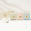 Set of three hand soap packaging boxes from the Armani Privé Les Eaux Hand Soaps Discovery Trio Gift Set with an irregular white sphere shaped hand soap bar on a sandy neutral coloured background | BEAUTE KNOWS AUSTRALIA
