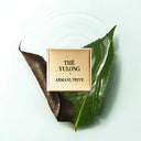 Armani Privé Les Eaux Hand Soaps Discovery Trio Gift Set's Thé Yulong scent on gold plate. The scent's commercial fragrance mood image on a brownish green and a vibrant green leaf | BEAUTE KNOWS AUSTRALIA