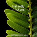 Close-up of green leaves with text 'Instantly thickens' and 'Certified Organic Amla'.