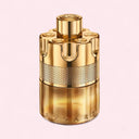 Gold Azzaro perfume bottle on a light pink background