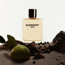 Burberry Hero perfume bottle with a lime and leaves on a textured surface
