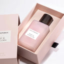 Pink perfume bottle with 'Banana Republic' label in a box on a white background
