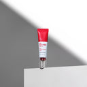 BEAUTE KNOWS Red and white Beauty of Majesty BOM AC Red Free Serum 30ml tube on a gray background