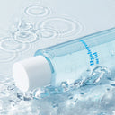 Clear blue Beauty of Majesty BOM Hyaluronic Acid Moisture Toner 200ml bottle with blue text label partially submerged in water, creating ripples.