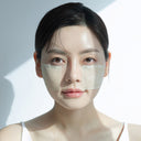 Woman wearing wet cotton pads soaked with Beauty of Majesty BOM Just One Artemisia Capillaris Extract Toner 150ml on a light background