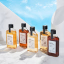 Five bottles of Beauty Of Majesty Just One Extract products with labels on a white surface and blue sky background