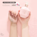Pink Beauty of Majesty BOM LIGHT ON In Shower Body Tone Up Lotion 290ml bottle held by hands with a light bulb icon above, on a pink background. comparison of before and after use