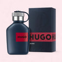 Hugo Boss perfume bottle and packaging on a light pink background