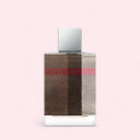 Perfume bottle with checkered design on a light pink background