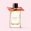 Burberry Garden Roses perfume bottle with a pink bow on a light pink background