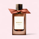 Burberry perfume bottle with a bow on a light pink background