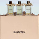 Three Burberry perfume bottles with a beige box featuring the Burberry logo.