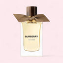 Burberry Ash Flower perfume bottle with a brown ribbon on a light pink background