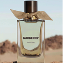Burberry Oud Storm perfume bottle with desert landscape in the background
