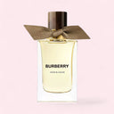 Burberry Snow Blossom perfume bottle with a brown ribbon on a light pink background