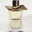 Burberry Snow Blossom perfume bottle with a gold bow on a light background