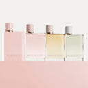 BEAUTE KNOWS Four Burberry perfume bottles in different colors on a pink background