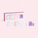 Bulgari perfume set with multiple bottles and packaging on a pink background