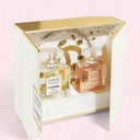 Chanel Coco Mademoiselle Eau de Parfum 50ml perfume bottle and Coco Mademoiselle Body Oil 100ml bottle in a decorative box on a light pink background