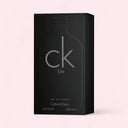 Black packaging of Calvin Klein CK Be perfume on a light pink background