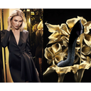 model Karlie Kloss in a black dress with gold mirrored background on the left side and Carolina Herrera Good Girl Supreme Eau De Parfum high-heel shoe shaped perfume bottle on a gold flower background on the right side