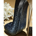 Carolina Herrera Good Girl Supreme Eau De Parfum black glittery high heel shoe shaped on a beige background with white flowers and berry