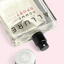 Allure Homme Sport perfume bottle on a light pink background