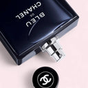 Chanel Bleu Eau de Toilette 150ml perfume bottle with cap on a light pink background