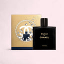 Bleu de Chanel parfum bottle and gold limited edition packaging on a light pink background