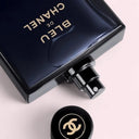 Chanel Bleu limited edition perfume bottle labeld with gold fonts on a light pink background