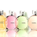 Four Chanel Chance perfume bottles in different colors on a reflective surface.