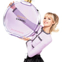 Person holding a large Chanel Chance Eau Splendide perfume bottle on a white background