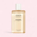 Chanel Coco Mademoiselle body oil 200ml bottle on a pink background