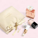 Chanel perfume bottle, packaging, and lip product on a pink background