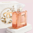 Chanel Coco Mademoiselle Eau De Parfum 100ml perfume bottle with packaging on a pink background