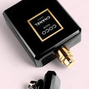 Black Chanel Coco Noir Eau de parfum 50ml perfume bottle with gold cap on a light pink background