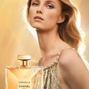 Chanel Gabrielle Essence Eau de Parfum perfume bottle with Rianne Van Rompaey a gold background