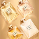 Four Chanel Gabrielle perfume bottles on a Golden Bronze background