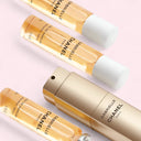 Gabrielle Chanel Eau de Parfum Twist and Spray perfume bottle with 3 20ml refillable vials on a light pink background